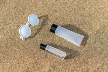 Summer beach layout with sunglasses and hand sanitizer on sand. Minimal Coronavirus outbreak....