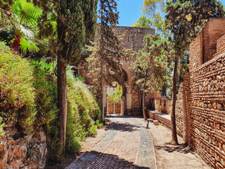 ancient stone archway, gate of the wall and the gardens of the Alcazaba in the city of Malaga,...