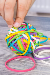 Preschooler hands playing with rubber bands or erasers. Development of kids motor skills,...