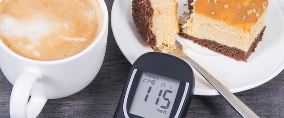 Glucose meter with high result sugar level, portion of sweet cheesecake and cup of coffee with milk. Nutrition during diabetes