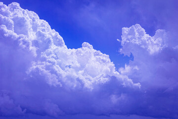 White lush clouds in blue sunny sky