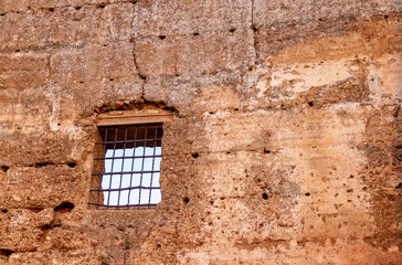 Fototapeta na wymiar Old window of Burgalimar Castle, caliphal fortress, built in the 10th century on a small hill overlooking the town of Baños de la Encina, located in the north of the province of Jaen (Spain)