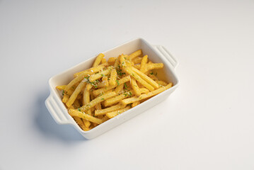 A bowl of crispy French fries decorated with parmesan cheese