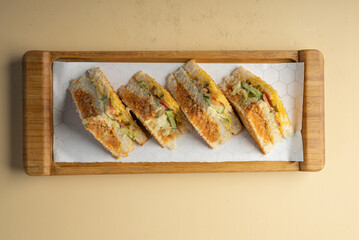 Vegetable club sandwich with Cheese on a wooden container