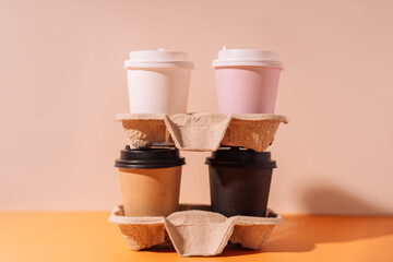 Paper cups in a tray stand on top of each other.