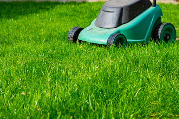 Seasonal maintenance works in garden, lawn movers in action, green grass cutting, lawn care, English lawn