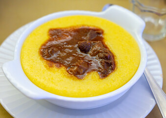 Traditional first course for lunch or dinner in Italy, yellow corn polenta porridge with stew...