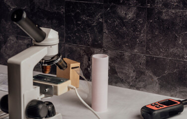 lab setup dedicated to the study of animal reproduction, featuring a microscope and liquid nitrogen tank crucial for storing biological specimens