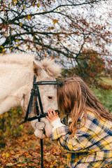 girl with horse in autumn park