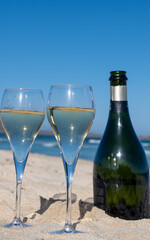 Pouring a glass of champagne on vacation, south of Fuerteventura, Canary islands, blue ocean, mountains