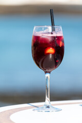 Glass of cold sangria wine served with orange in beach cafe, Corralejo, Fuerteventura, Spain