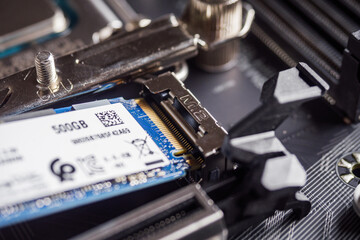 a specialist installs a solid-state drive in the m2 connector