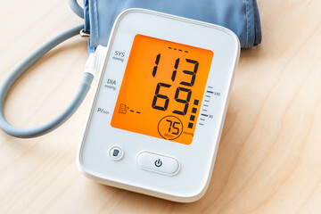 Automatic blood pressure monitor, Medical electronic tonometer on wooden table