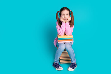 Full body photo of cute little girl sit moody pile books dressed stylish pink clothes isolated on...