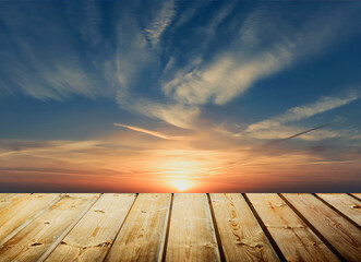 Empty wooden table. Sunset sky background.