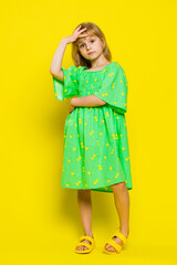 Face palm. Shame on you. Upset young blonde child girl kid making face palm gesture, feeling bored, disappointed in result, bad news. Little preteen children isolated on yellow background. Vertical