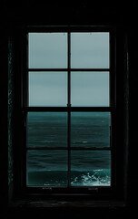 Photo of window looking out to the ocean with black background. Lonely Concept.