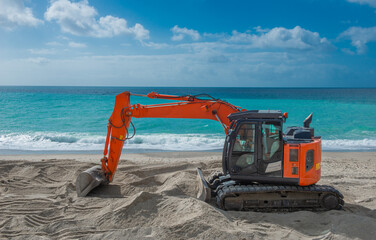 Excavator smooths the beach sand