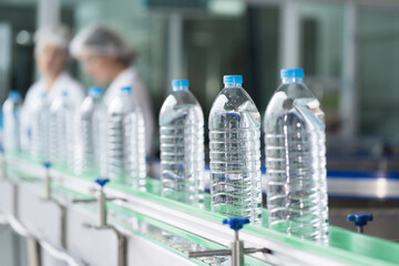 Plastic bottled water inside automated conveyor belt production line in drinking water factory