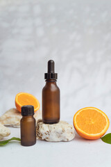 Amber Glass bottle with vitamin C . Vitamin C serum with orange fruit