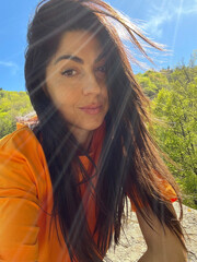 Beautiful brunette woman  in the summer mountain 