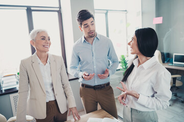 Photo of two employees mature boss woman talking office team meeting discussion colleagues working...