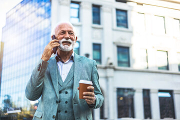 Shot of a mature businessman using his smartphone to make a phone call