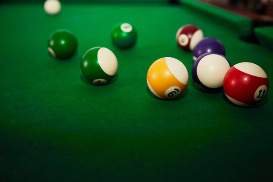 Billiard balls for playing pool on the green cloth of a billiard table, playing “eight” in billiards