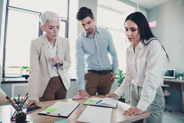 Photo of two employees mature boss woman discuss documents office team meeting discussion...
