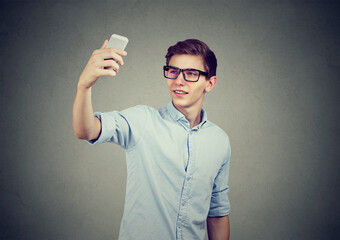 Smiling young man taking a selfie 