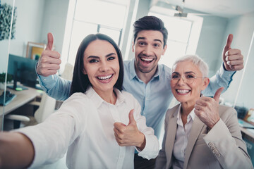 Photo of positive business people make selfie show thumb up sign in workplace workstation