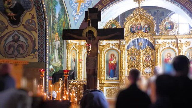 People worshiping Jesus on the cross in an orthodox christian church
