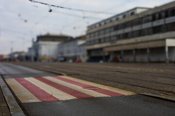 Colorful pedestrian crossing in front of the main train station in the city. The background is...