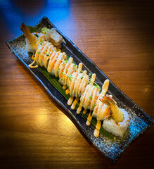Prawn tempura roll at table.