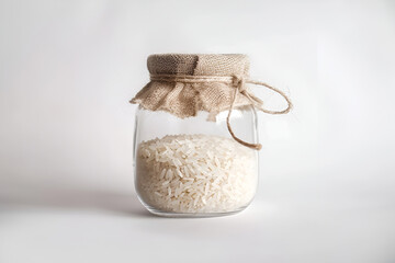 Rice in a plain glass jar. White background