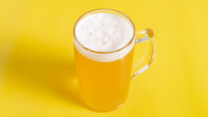 Beer glass isolated on yellow