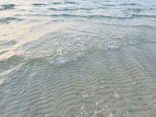 Transparent sea water, natural sea surface background, sea water, sand bottom