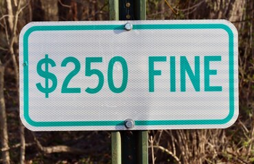 A close view of the metal fine sign.