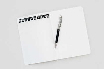 Filling in the diary, the inscription Motivation in the notebook in a dot