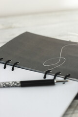 Notepad diary with pen on the desktop