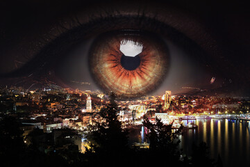 Double exposure of night cityscape and woman with beautiful eye, closeup