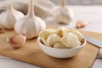 Fototapeta na wymiar Fresh garlic on white wooden table, closeup