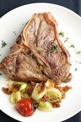 Delicious fried beef meat and vegetables on table, top view