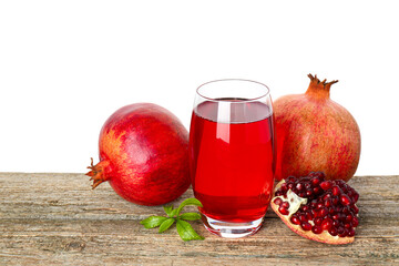 Refreshing pomegranate juice in glass, leaves and fruits on wooden table against white background - obrazy, fototapety, plakaty