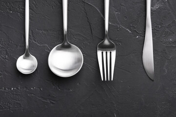 Beautiful cutlery set on black table, flat lay