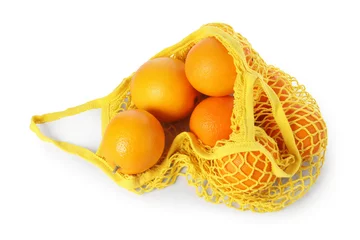Foto op Aluminium Fresh oranges in yellow string bag isolated on white, top view © New Africa