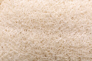 Loofah sponge as background, top view. Personal hygiene product