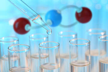 Test tubes and molecule model in laboratory, closeup