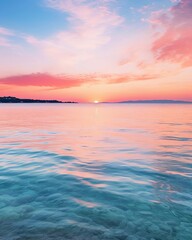 Fototapeta premium The setting sun casts a pink and purple glow over the calm sea.