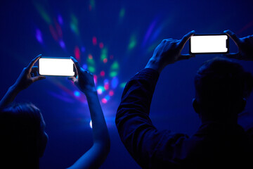 Smartphone, mockup or fans at concert filming performance, recording memories and taking picture....